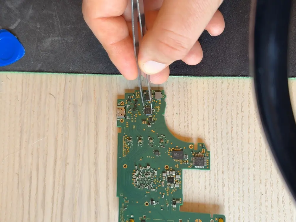 The Nintendo Switch Lite main board with the USB-C port area exposed, seen at normal magnification.
