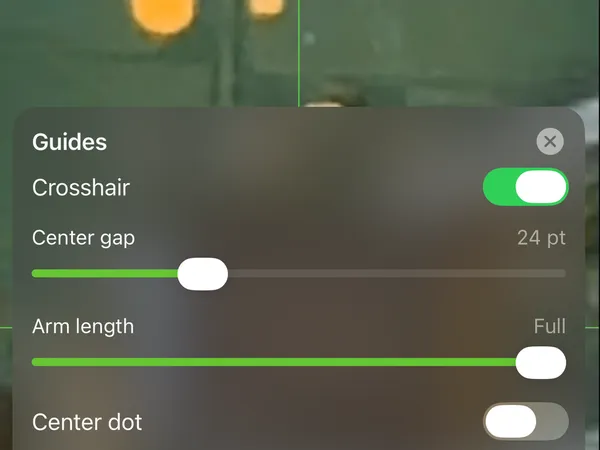 A green crosshair guide over a circuit board, with the guides panel open below it.