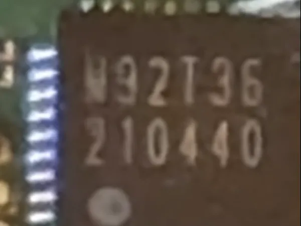 A frozen frame pinched in on the M92T36 marking, with the chip's pins sharp along the left edge.