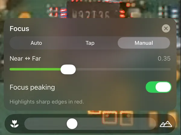 The focus panel set to manual, with a near-to-far slider and focus peaking switched on.